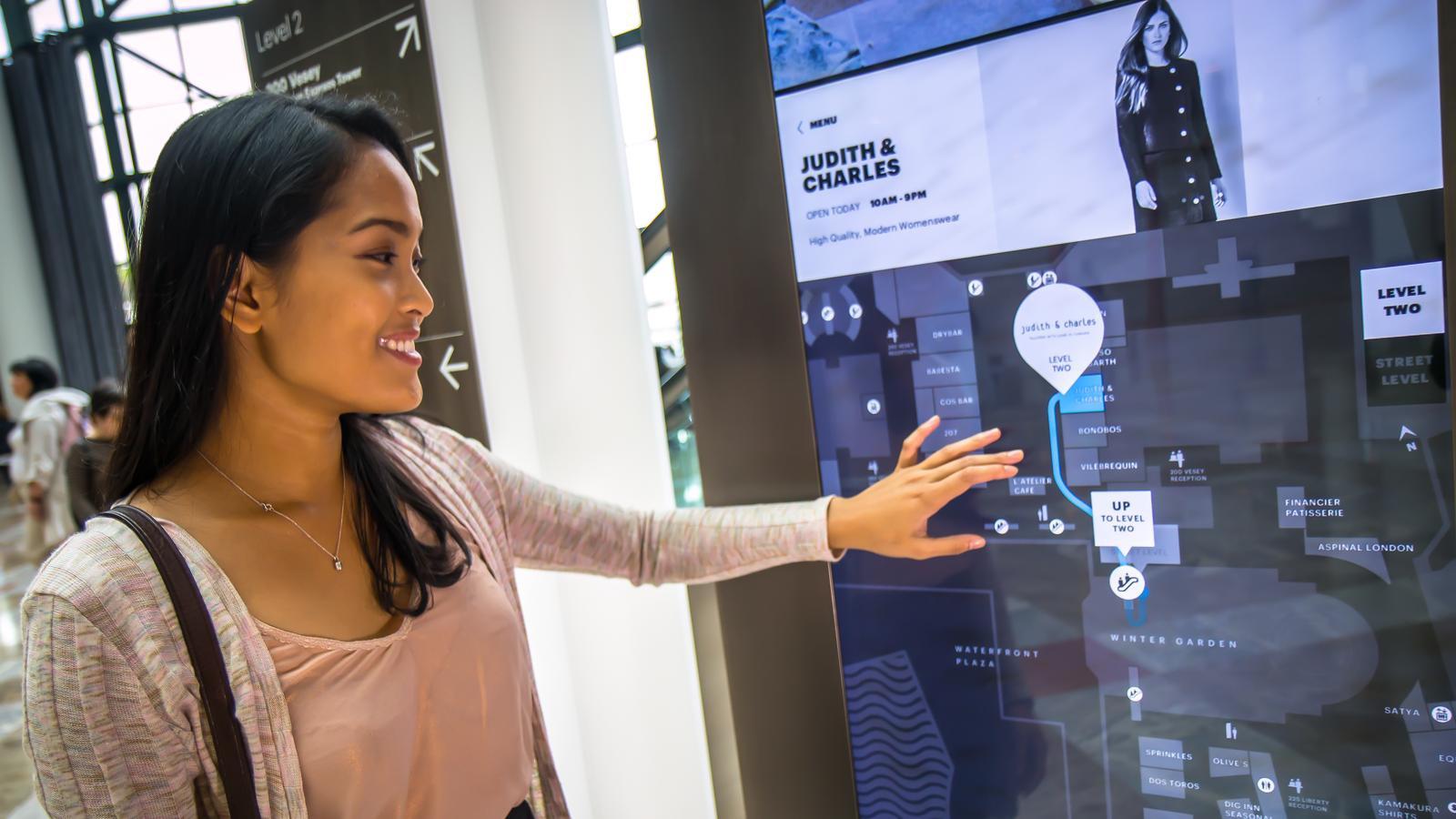 A visitor finding a store on the kiosk's map